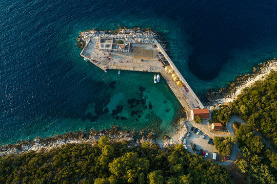 Aerial view of a small pier for ferry along the coast facing the Adriatic Sea near Lastovo, Croatia.