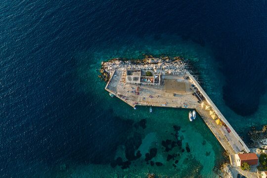 Aerial view of a small pier for ferry along the coast facing the Adriatic Sea near Lastovo, Croatia.