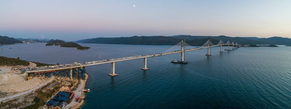 Aerial view of Peljeski bridge, a suspended railroad and highway under construction crossing the Bay of Mali Ston in Croatia.