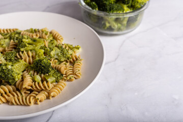 Fusilli pasta with broccoli on a white background. Typical vegetarian food.