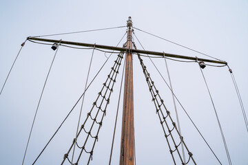 Ropes and rope ladder on a sailing ship with cloudy background
