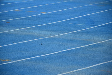 Curved running track on a blue field