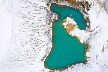 rial view of snow covered mountain around beautiful lake ice
