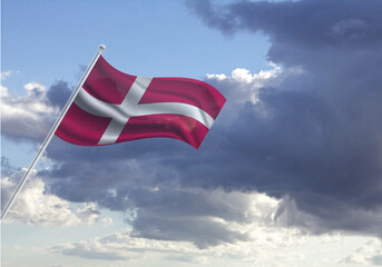 Flag of the Denmark on a stick, dark clouds in the background