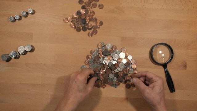 A man sorting and counting coins