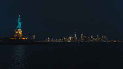 Statue of Liberty by night with Manhattan  © Clement