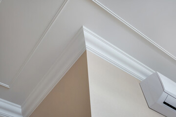 Detail of corner ceiling cornice with intricate crown molding.