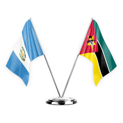 Two table flags isolated on white background 3d illustration, guatemala and mozambique - obrazy, fototapety, plakaty
