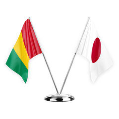 Two table flags isolated on white background 3d illustration, guinea and japan