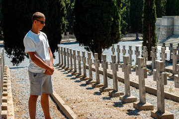 Young man visiting the cemetery