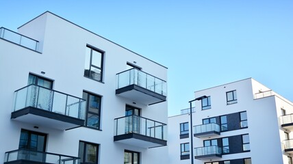  Facade of a modern apartment condominium in a sunny day. Modern condo buildings with huge windows...