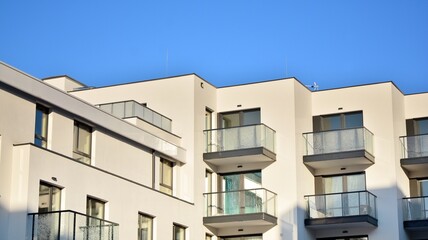  Facade of a modern apartment condominium in a sunny day. Modern condo buildings with huge windows and balconies.