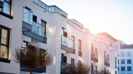  Facade of a modern apartment condominium in a sunny day. Modern condo buildings with huge windows and balconies. © Grand Warszawski