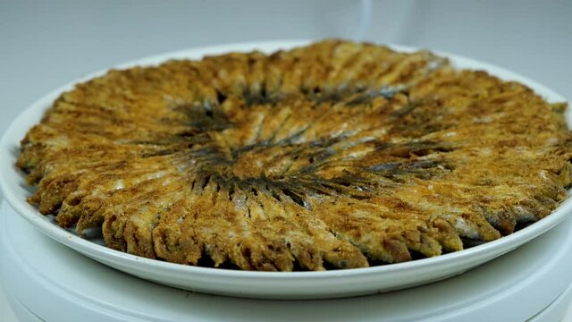 Turkish fried anchovy (hamsi)  served on with white plate in black
