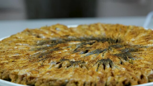 Turkish fried anchovy (hamsi)  served on with white plate in black