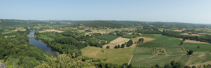 Fototapeta na wymiar Amazing green view from a castle near the dordogne river around some fields cultivated. Panoramic picture