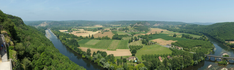 Fototapeta na wymiar Amazing green view from a castle near the dordogne river around some fields cultivated. Panoramic picture