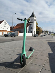 Green electric scooter parked at Kaunas