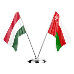 Two table flags isolated on white background 3d illustration, hungary and oman