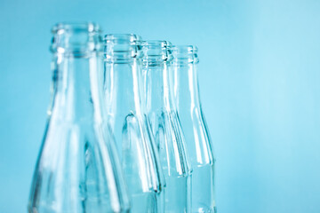 Some glass bottles with a bright blue background