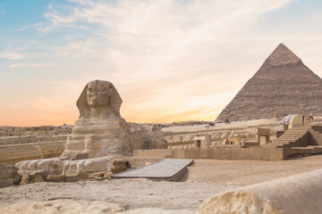 Great Sphinx against the background of the pyramids of the pharaohs Cheops, Khafren, and Mikerin in Giza, Egypt