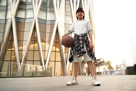 outdoor portrait of an asian  teenage basketball player