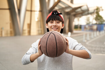 happy asian teenage basketball player