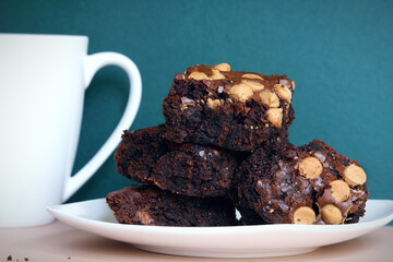 Cup of coffee with a plate of chocolate brownies