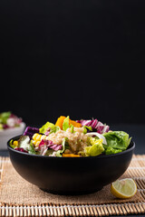 Fresh organic vegetables salad with quinoa seed in bowl on black background, Healthy Vegan food