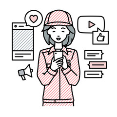 立ってスマートフォンでさまざまなSNSで楽しく交流する作業員の女性