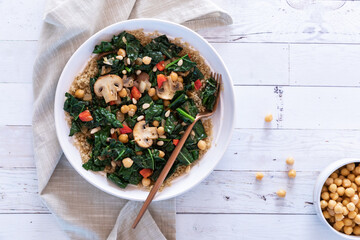 Top down view of a sauteed superfood salad bowl, topped with chickpeas