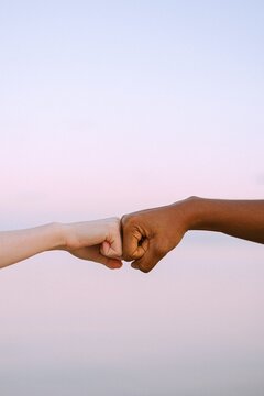 Cropped image of two hands fist bump