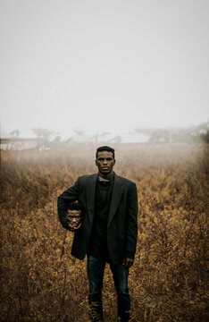 Graphic image of man in dark jacket holding his duplicate head