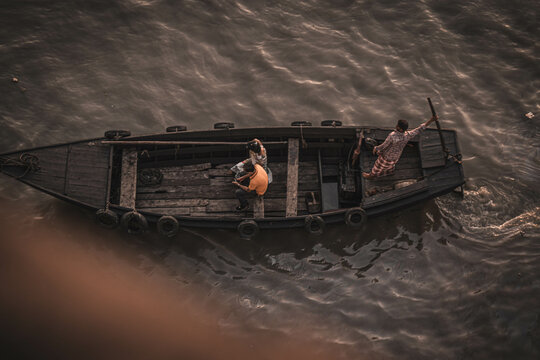 Top View Of Men On Brown Boat During Sunset