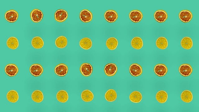 Colorful pattern of dried grapefruits and oranges slices. Seamless pattern with dried grapefruit and orange chips. Pop art design. Realistic animation. 4K video motion