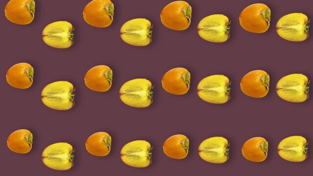 Colorful pattern of fresh orange persimmons. Top view. Seamless pattern with persimmon. Pop art design. Realistic animation. 4K video motion