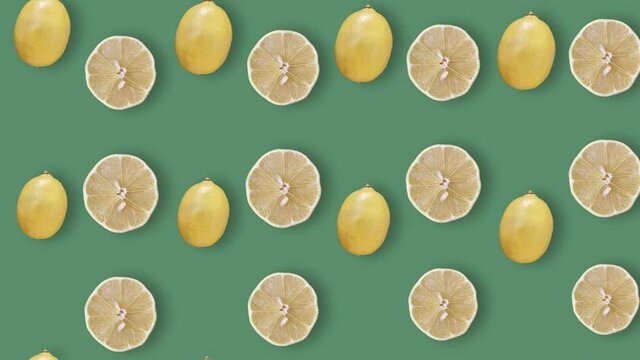 Colorful fruit pattern of fresh lemons on green background with shadows. Seamless pattern with lemon slices. Realistic animation. 4K video motion