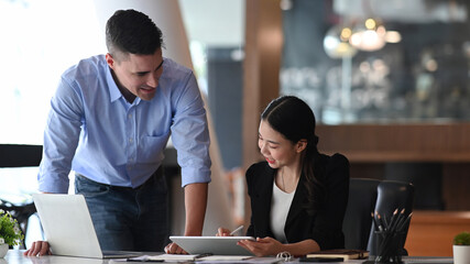 Two business colleagues discussing business ideas for new project together.