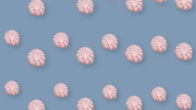 Colorful pattern of pink zephyr on grey background. Seamless pattern with zephyr. Marshmallow. Top view. Realistic animation. 4K video motion