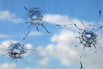 Bullet hole in dirty glass on a white background.