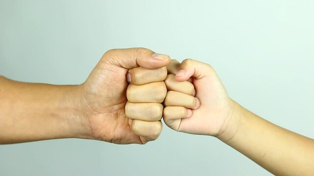 Fist bumping between father and son , in studio  Chiangmai  Thailand.