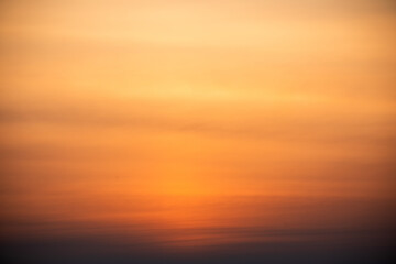 Naklejka na ściany i meble Dramatic sunset, the sun's rays shine through the clouds.