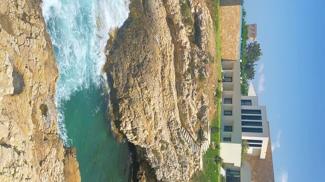 Vertical Shot Of Rocky Shoreline At The Luxury Residence Of Fidar Beach House In Jbeil, Lebanon. Panning Left