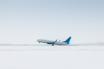 Takeoff of a passenger jet plane in a severe snowstorm