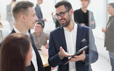 colleagues discussing current tasks standing in the office