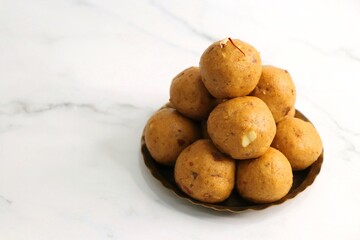 Indian Traditional Sweet Food Besan ke Laddu. Made using gram flour, sugar, and ghee. Indian festival sweet. Diwali faral or snacks. copy space. Gram flour sweet Ladoo. 