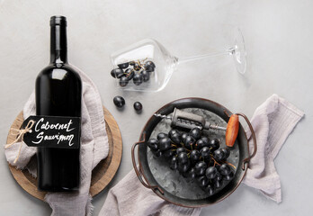 Red wine assortment with appetizers on light gray background.