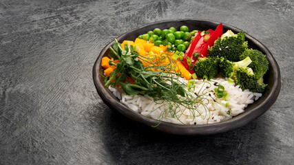 Bowl with rice, broccoli , pumpkin and microgreens.