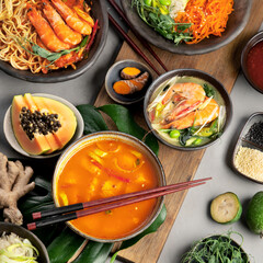 Asian dishes variety on gray background.