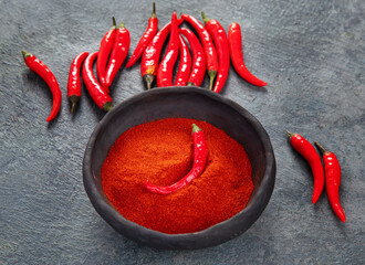 Fototapeta Red chili or chilli cayenne pepper on dark background. obraz